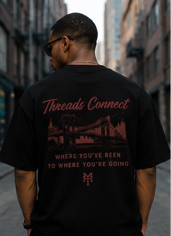 Model wearing the Threads Connect graphic tee on a city street